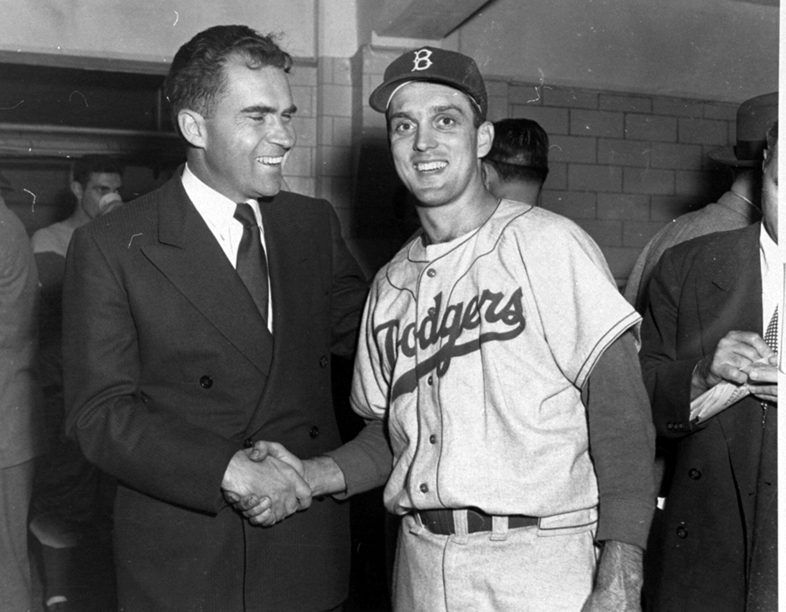 Sen. Richard Nixon, GOP Vice Presidential candidate, has a smile and a handshake for Brooklyn Dodgers hurler Carl Erskine after his eleven-inning, 6-5 win over the Yankees in the fifth World Series game at Yankee Stadium in New York City, October 5, 1952.