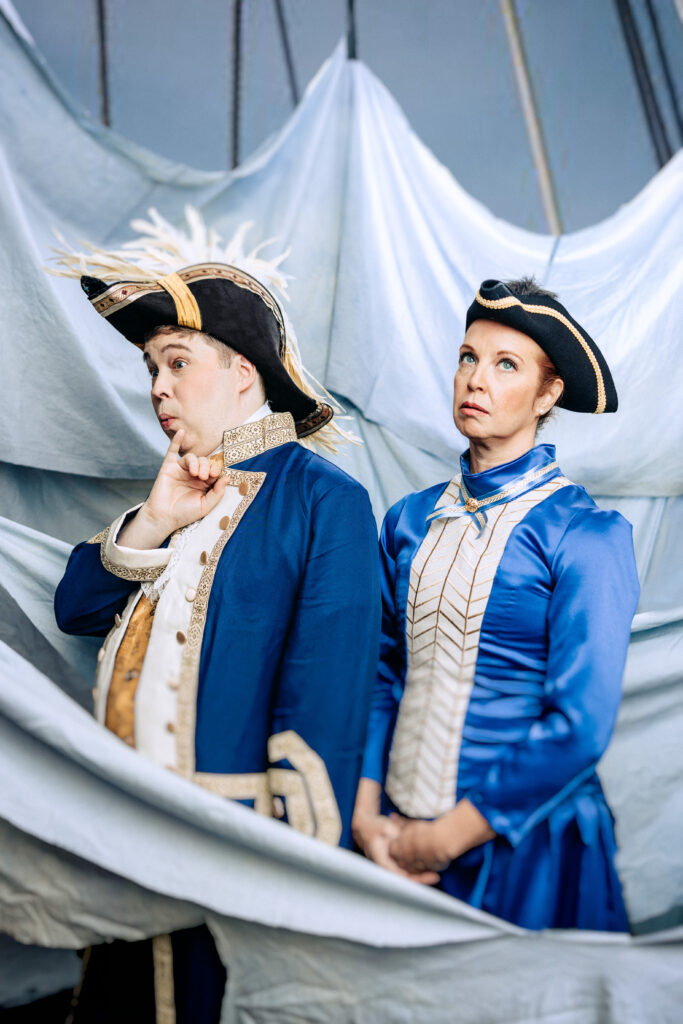 Sir Joseph Porter, uncharacteristically puzzled, played by Erik Hansen, with Cousin Hebe, one of his many “sisters, cousins and aunts,” that comprise his consort, played by Jen Dorre.