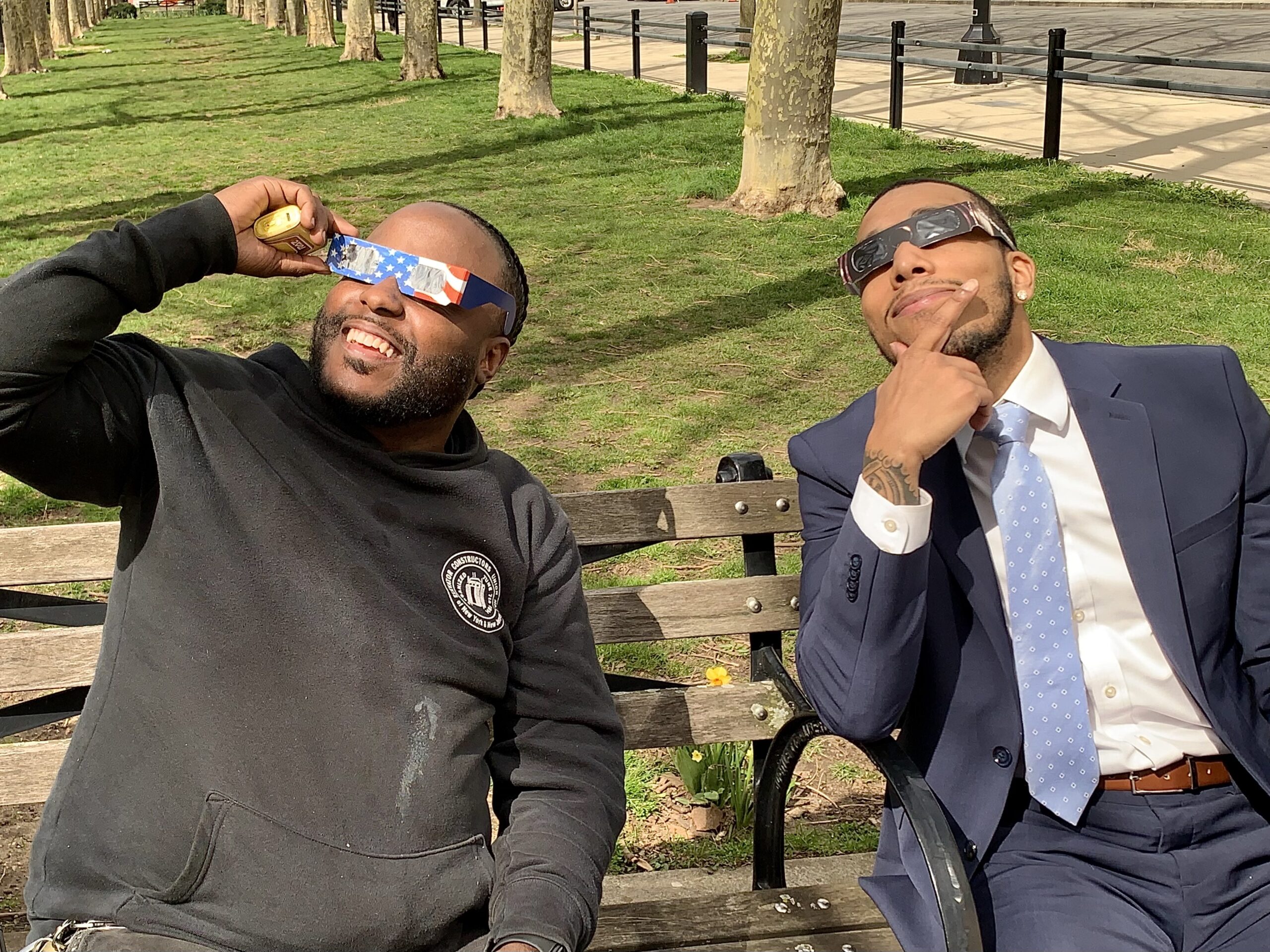 Two buddies enjoyed a moment of levity while watching the eclipse from a bench near Federal Court in Downtown Brooklyn. Brooklyn Eagle photo by Mary Frost