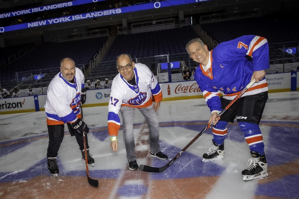 Mark Hoorwitz of Lexitas drops the puck for the ceremonial face-off between Joe Carola and John Dalli, kicking off the charity hockey game in support of the Tunnel to Towers Foundation at Tunnel to Towers hockey game.