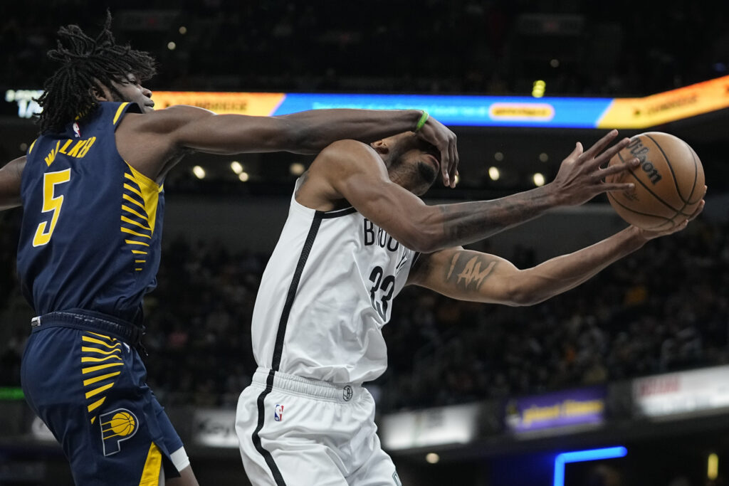 <b>INDIANAPOLIS — New rules — you can’t look when you’re shooting:</b> Brooklyn Nets' Nic Claxton (33) is fouled by Indiana Pacers' Jarace Walker (5) during the first half of an NBA basketball game on Monday, April 1, 2024, in Indianapolis. The Nets play their last home game of the regular season on April 10 against the Toronto Raptors, and their closing away game just across the river at Madison Square Garden against the NY Knicks on April 12. The Nets, Brooklyn’s professional-league home team, might not be part of the collegiate March Madness, and they certainly have a way to go to increase their standing from Number 11.<br>Photo: Darron Cummings/AP