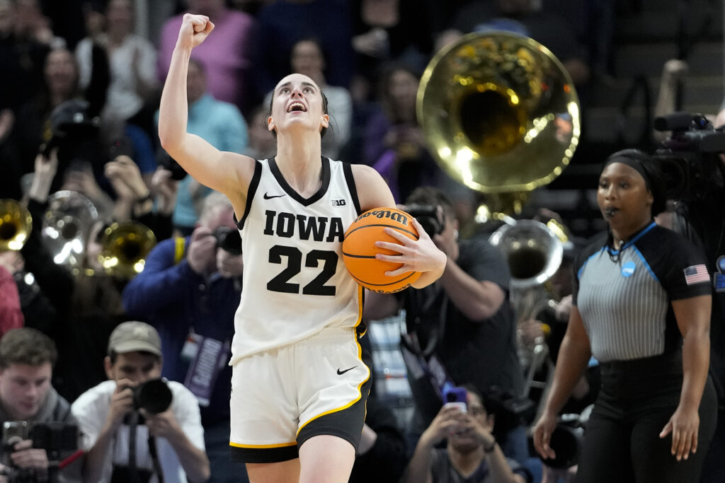 <b>ALBANY — One player who deserves a brass band:</b> Iowa guard Caitlin Clark (22) celebrates after defeating LSU in an Elite Eight round college basketball game during the NCAA Tournament on Monday, April 1, 2024, in Albany, NY. Clark’s team, the Iowa Hawkeyes, have enjoyed a conference 15-1 victory record and a 33-4 overall record this season. The Iowa Hawkeyes represent the University of Iowa.<br>Photo: Mary Altaffer/AP