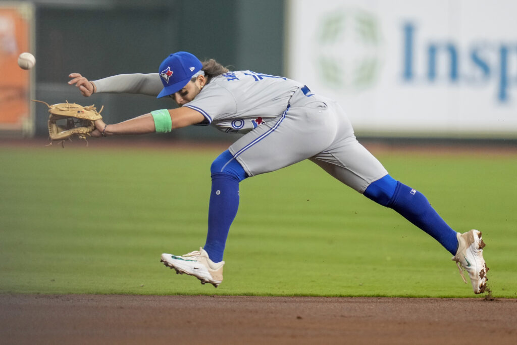 Toronto Blue Jays shortstop Bo Bichette can't reach a line drive by Houston Astros' Yainer Diaz, who singled during the first inning of a baseball game Wednesday, April 3, 2024, in Houston. (AP Photo/Eric Christian Smith)