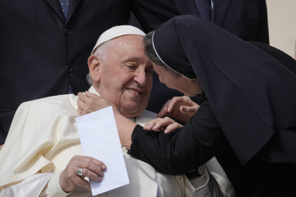Pope Francis is hugged by a nun at the end of his weekly general audience in St. Peter's Square, at the Vatican, Wednesday, April 17, 2024. (AP Photo/Andrew Medichini)