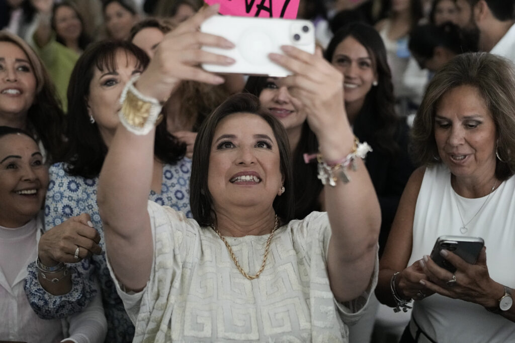 Presidential candidate Xóchitl Galvez poses for a selfie photo with supporters during a campaign rally in Huixquilucan, Mexico, Thursday, April 11, 2024. General elections are set for June 2. (AP Photo/Marco Ugarte)