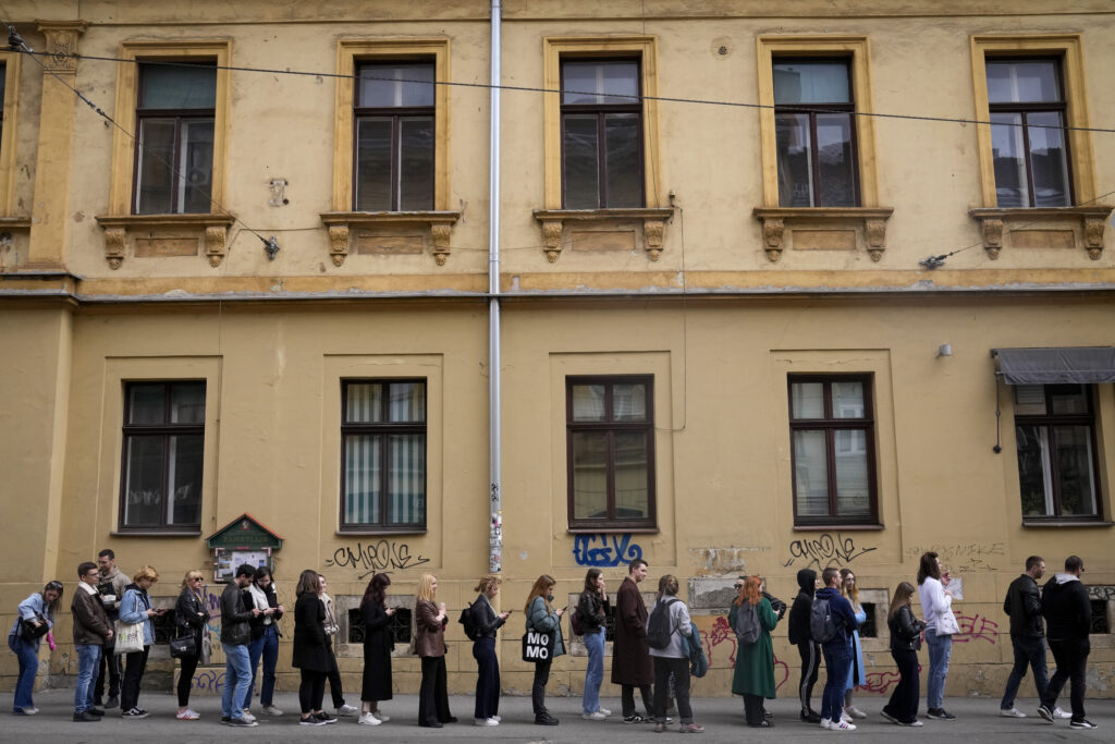 Voters wait near a polling station in Zagreb, Croatia, Wednesday, April 17, 2024. Croatia is voting in a parliamentary election after a campaign that centred on a bitter rivalry between the president and prime minister of the small European Union and NATO member. (AP Photo/Darko Bandic)