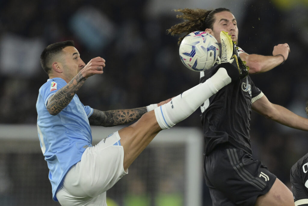 Juventus' Adrien Rabiot, right, jumps for the ball with Lazio's Matias Vecino during the Italian Cup semi-final soccer match between Lazio and Juventus at Rome's Olympic Stadium, Italy, Tuesday, April 23, 2024. (Alfredo Falcone/LaPresse via AP)