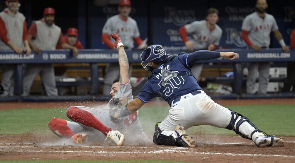 Tampa Bay Rays catcher Rene Pinto (50) tags out Los Angeles Angels' Zach Neto at home during the ninth inning of a baseball game Wednesday, April 17, 2024, in St. Petersburg, Fla. (AP Photo/Steve Nesius)