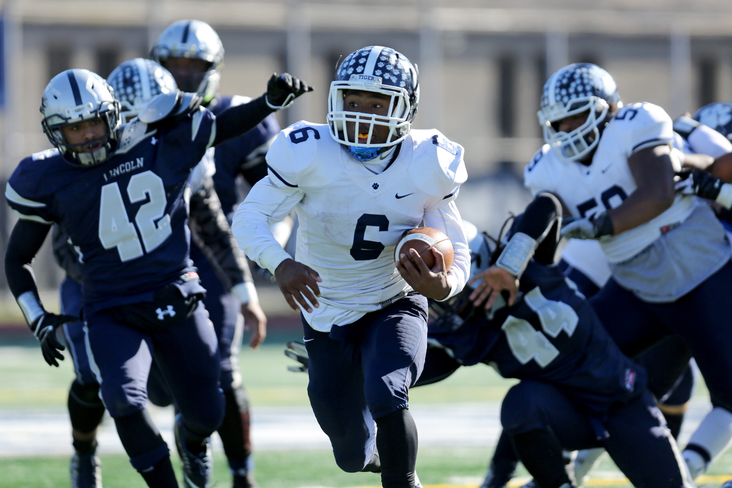 Fort Hamilton Tigers Troy Booker #6 breaks through the line on a first half touchdown run against the Lincoln Railsplitters during a high school football game on Saturday, November 21, 2015 in Brooklyn, NY. Fort Hamilton won and advance in the PSAL playoffs. (AP Photo/Gregory Payan)
