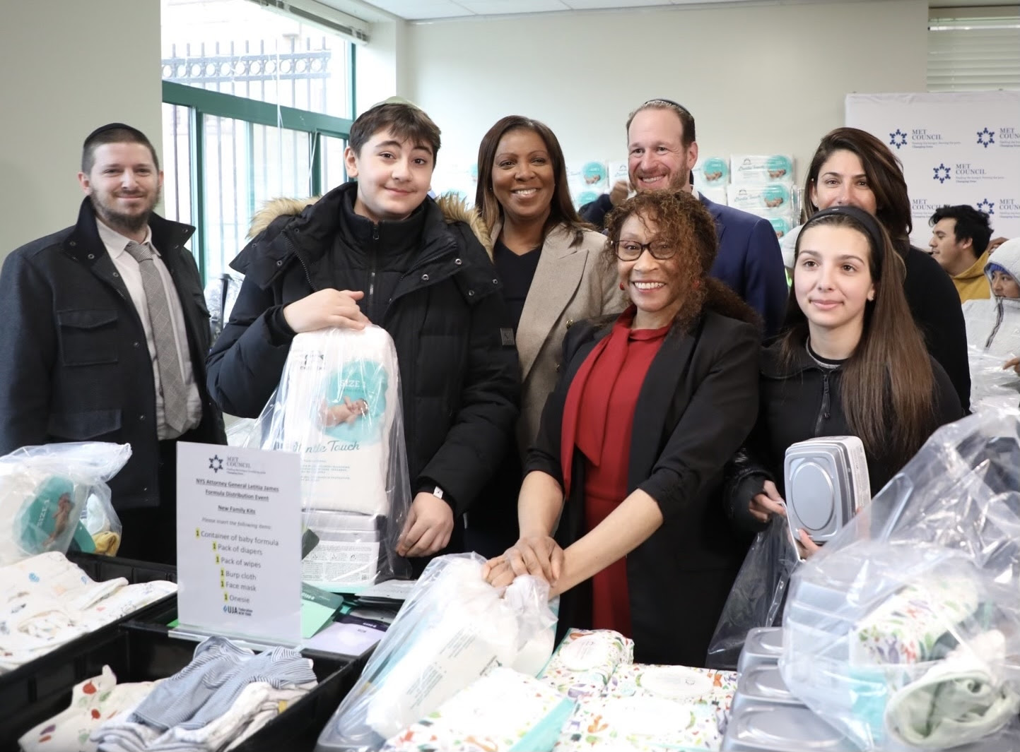 AG James, Met Council CEO David Greenfield and volunteers assemble baby supply care packages with baby formula for low-income parents. Photo courtesy of the Office of the Attorney General