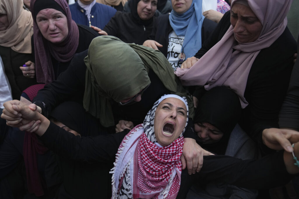 Palestinian Fayrouz Safi cries while she takes the last look at the body of her son Aysar Safi, 20, at the family house during his funeral in the West Bank refugee camp of Jalazoun, north of Ramallah Wednesday, May 15, 2024. Safi was killed during clashes with Israeli forces at the northern entrance of al-Bireh city, Palestinian ministry of health said. (AP Photo/Nasser Nasser)