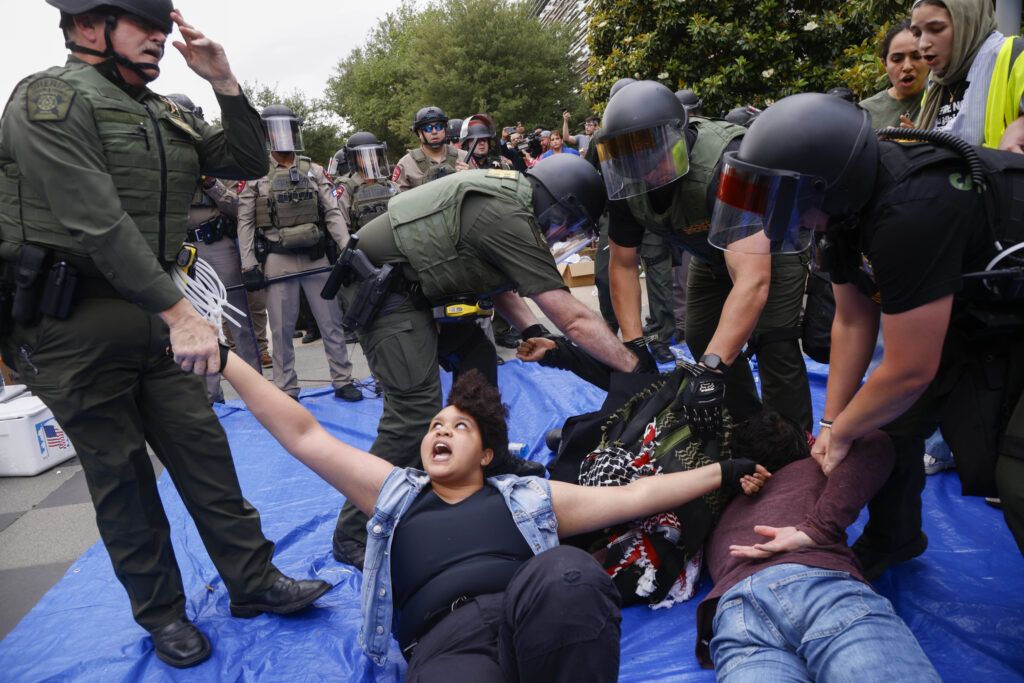 Protesters are taken into custody as law enforcement dismantle an encampment by pro-Palestinian students at the University of Texas at Dallas' Chess Plaza on Wednesday, May 1, 2024, in Richardson, Texas. (Juan Figueroa/The Dallas Morning News via AP)
