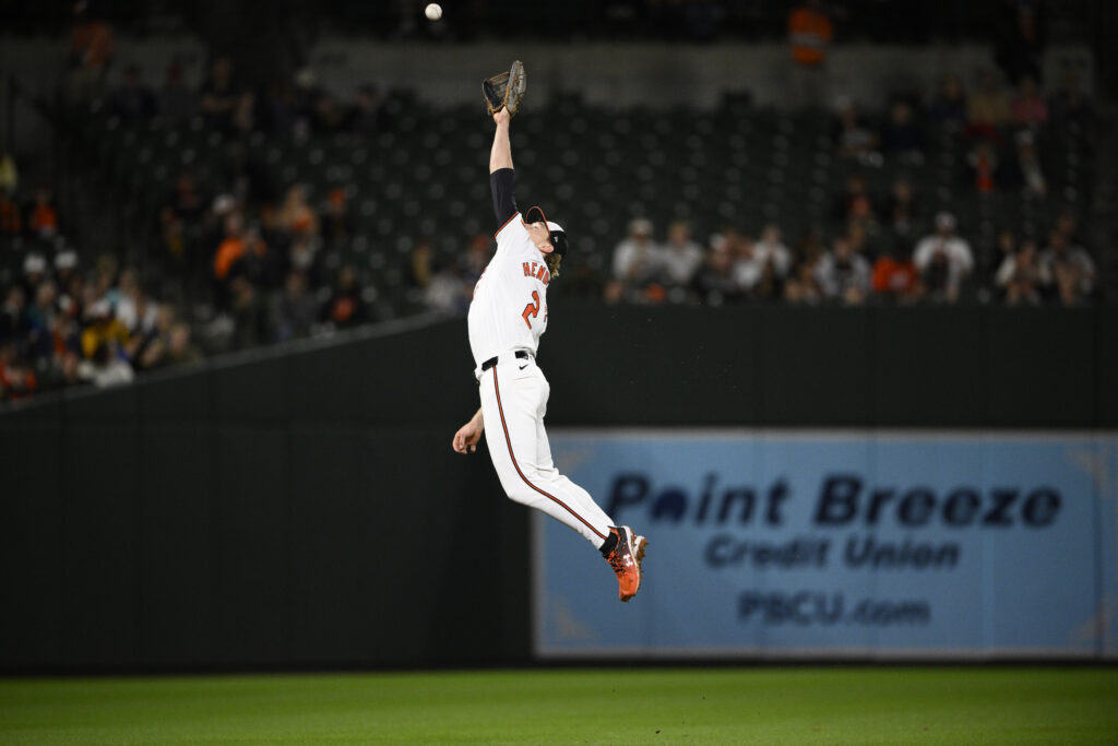 Baltimore Orioles shortstop Gunnar Henderson leaps for but misses a ball that went for a single by Boston Red Sox's Rob Refsnyder during the eighth inning of a baseball game, Wednesday, May 29, 2024, in Baltimore. (AP Photo/Nick Wass)