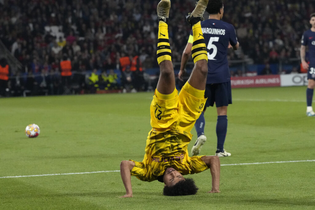 Dortmund's Karim Adeyemi flips after a challenge with PSG's Marquinhos during the Champions League semifinal second leg soccer match between Paris Saint-Germain and Borussia Dortmund at the Parc des Princes stadium in Paris, France, Tuesday, May 7, 2024. (AP Photo/Frank Augstein)