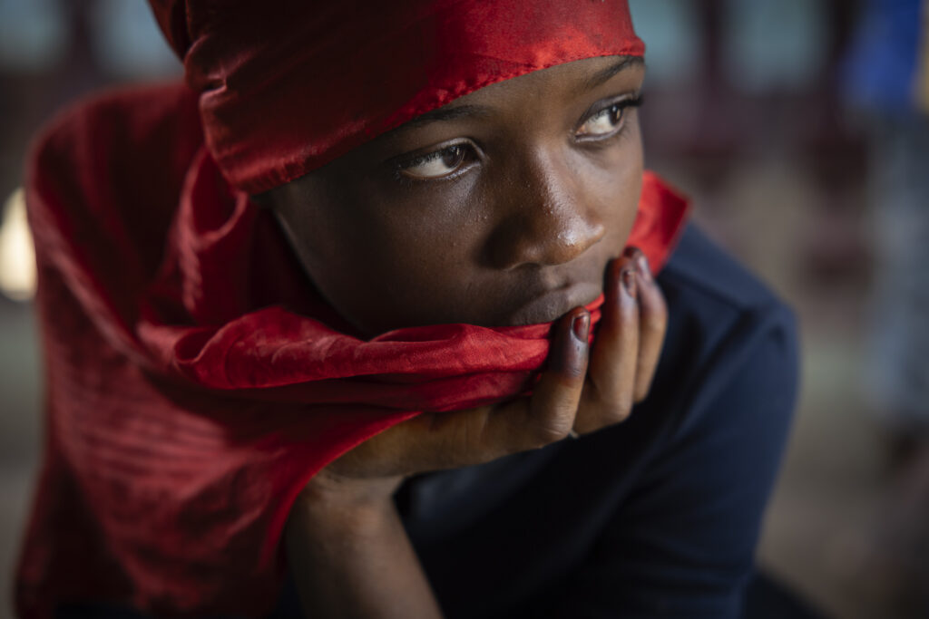 A girl looks on in the family home of the late Ousmane Sylla ahead of his body's arrival in Conakry, Guinea, Monday, April 8, 2024. (AP Photo/Misper Apawu)