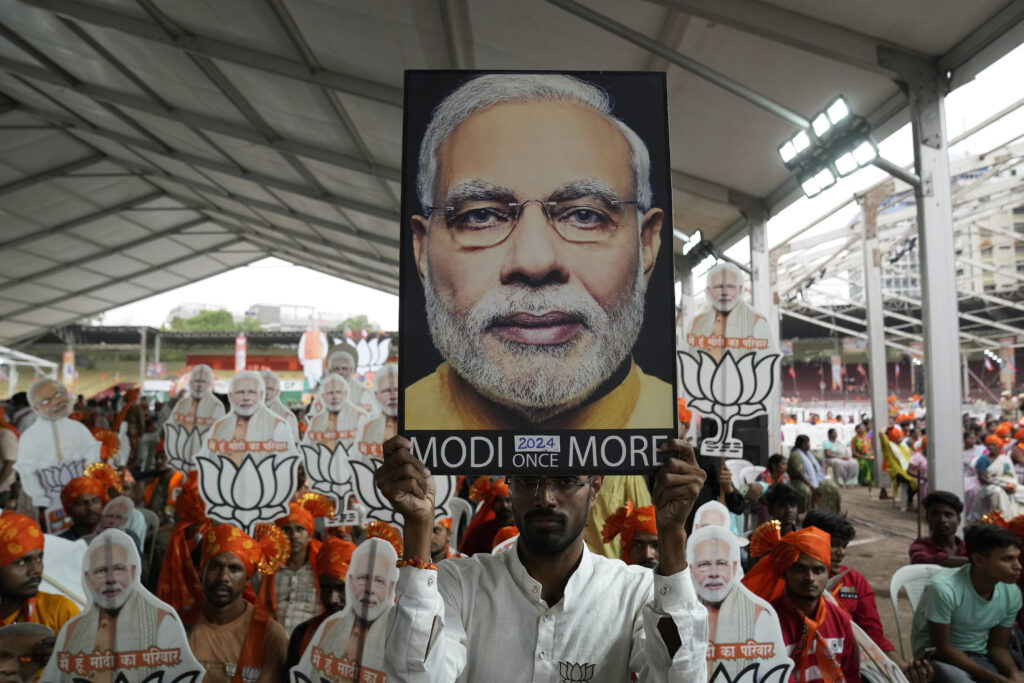 Bharatiya Janata Party (BJP) supporters carry portraits of Prime Minister Narendra Modi as they attend a public rally addressed by Modi in Hyderabad, India, Friday, May 10, 2024. (AP Photo/Mahesh Kumar A.)