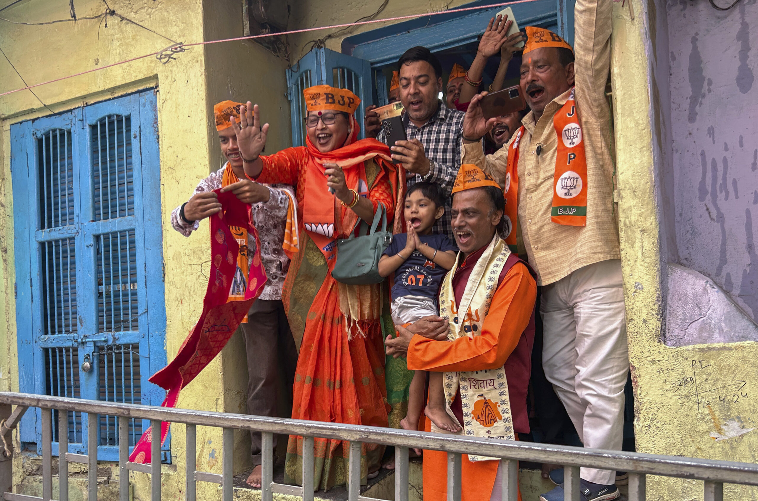Supporters react as Indian Prime Minister Narendra Modi, arrives to worship at the Kaal Bhairav temple before filing his nomination papers to contest as a candidate for the parliamentary elections in Varanasi, Uttar Pradesh state, India, Tuesday, May 14, 2024. Varanasi will go to polls on June 1 in the seventh and last phase of the six-week-long election. (AP Photo/ Rajesh Kumar Singh)