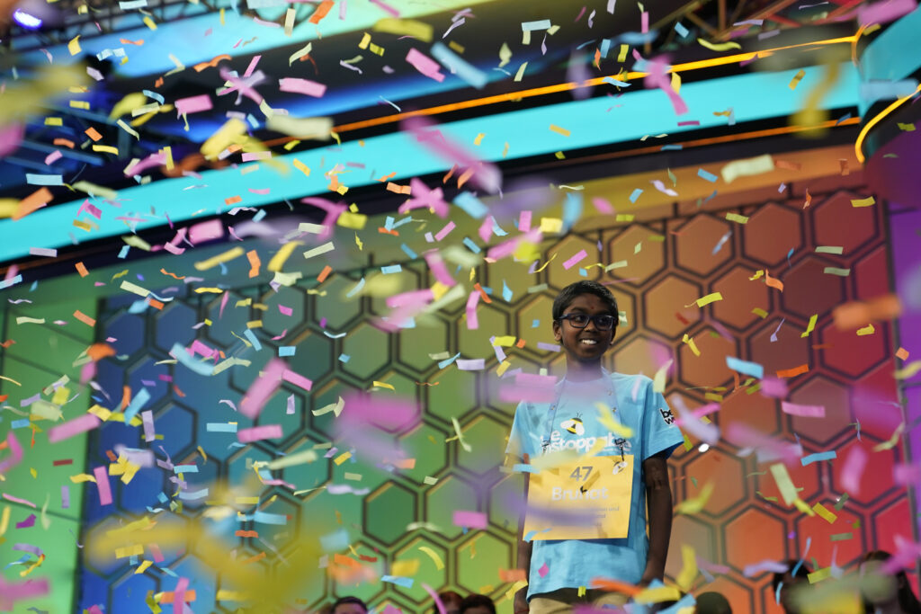 Bruhat Soma, 12, of Tampa, Fla., stands amid confetti after winning the Scripps National Spelling Bee, in Oxon Hill, Md., Thursday, May 30, 2024. (AP Photo/Nathan Howard)