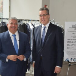 District Attorney Eric Gonzalez and attorney Michael Farkas proudly display a collection of approximately 100 suits gathered during their suit drive at the DA's Office on Jay Street, aimed at empowering Brooklyn's youth. Brooklyn Eagle photos by Robert Abruzzese