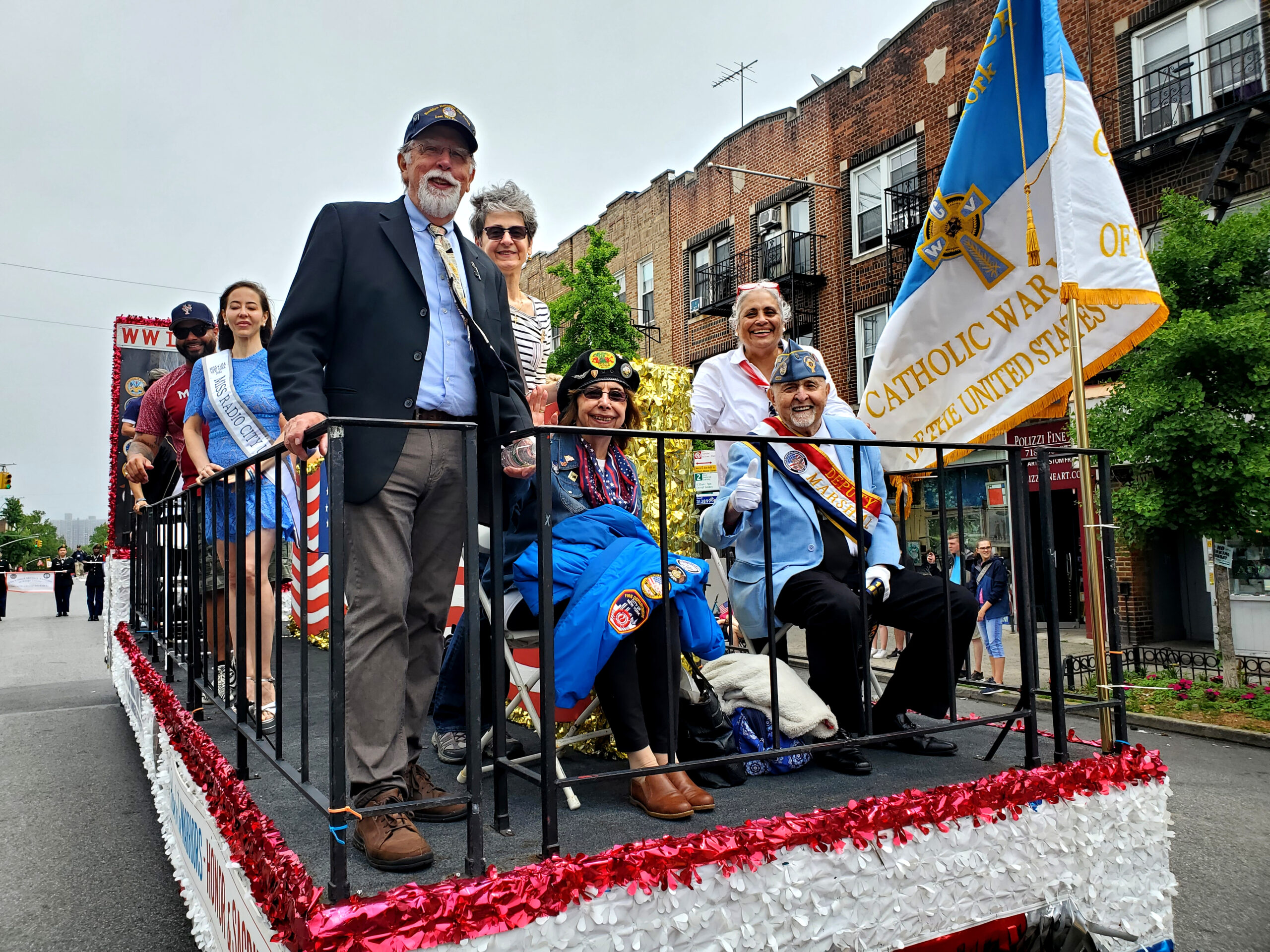 ‘Floating’ up the avenue: Ray Aalbue (wearing tie), chairman of the Brooklyn Memorial Day Parade and executive director of the United Military Veterans of Kings County; Marianne Aalbue; Deputy Marshal Vincent Sampieri, U.S. Navy veteran, Catholic War Veterans (seated); and Connie Ranocchia, parade president (standing). Eagle photos by Arthur De Gaeta
