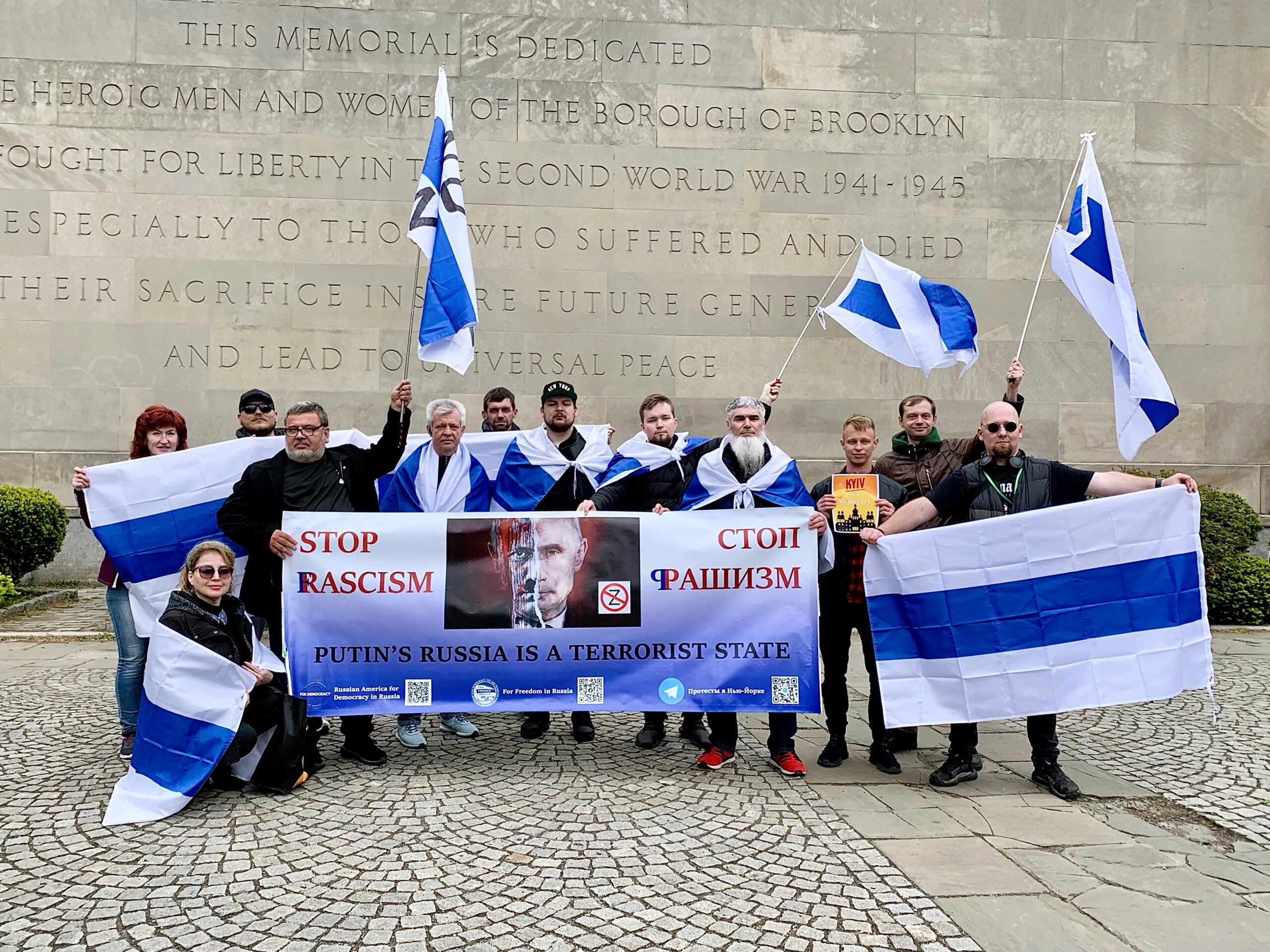Russian and Ukrainian members of the group “Russian America for Democracy in Russia” marched over the Brooklyn Bridge and rallied in front of the Brooklyn War Memorial in Cadman Park on Saturday.