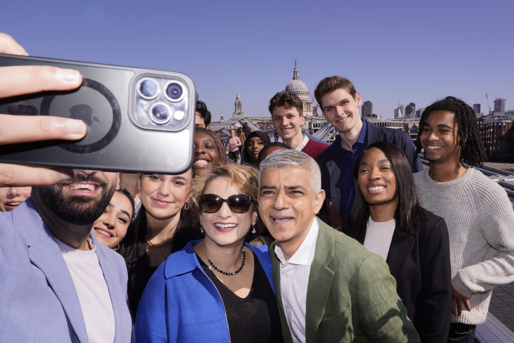 The newly re-elected Labour Party Mayor of London Sadiq Khan, centre right, poses with his wife Saadiya Ahmed and party workers on the Millennium Bridge before his swearing in ceremony in London, Tuesday, May 7, 2024. (AP Photo/Alberto Pezzali)