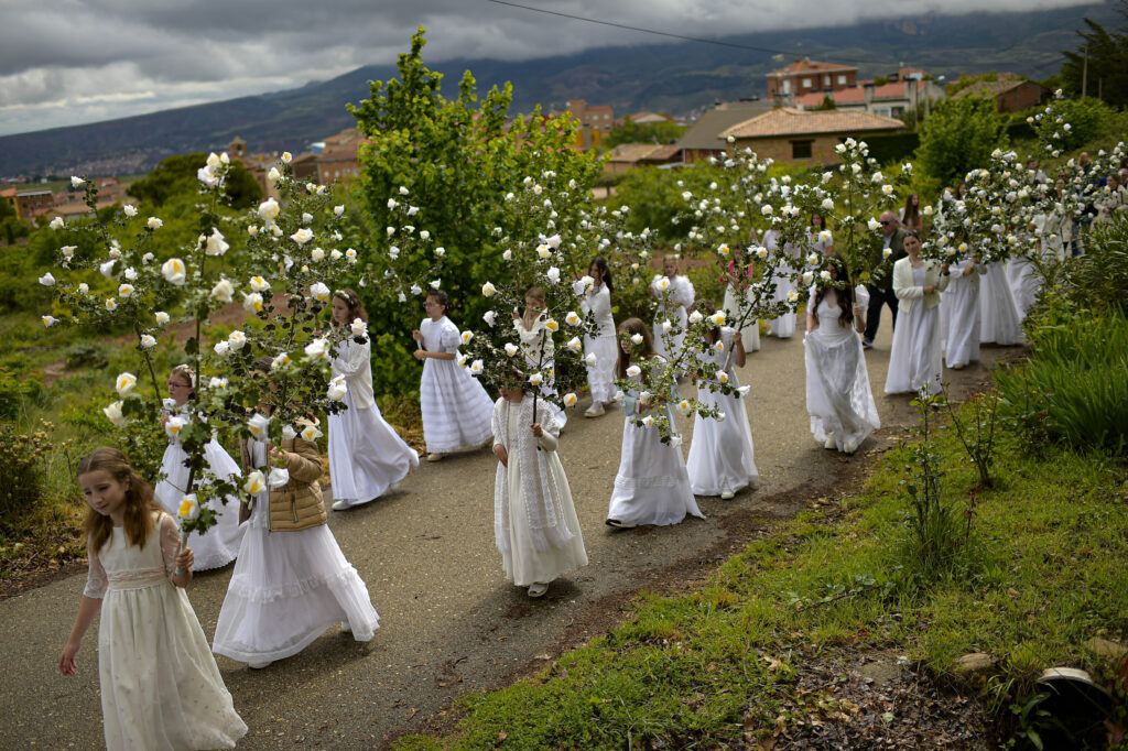 "Las Doncellas" (maidens) dressed in white take part in the pilgrimage "The Maidens" in honor of the Virgin, in Sorzano, northern Spain, on Sunday, May 19, 2024. According to ancient traditions, the pilgrimage "The Maidens" is in honor of the spring season and the fertility of women, today is also in honor of the Virgin Mary. (AP Photo/Alvaro Barrientos)