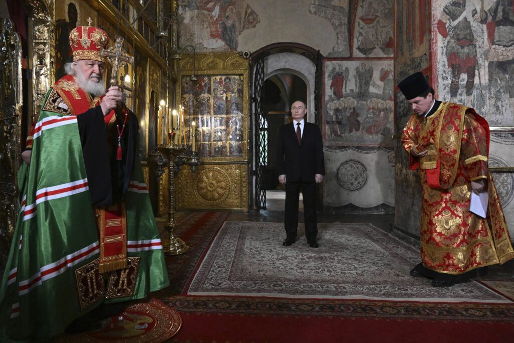 Russian President Vladimir Putin, center, attends a prayer service conducted by Patriarch Kirill of Moscow and all Russia, left, following an inauguration ceremony at the Kremlin's Annunciation Cathedral in Moscow, Russia, Tuesday, May 7, 2024. (Alexey Maishev, Sputnik, Kremlin Pool Photo via AP)