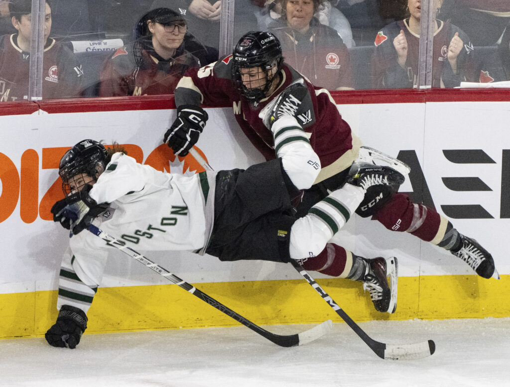 Boston's Sidney Morin, loeft, is upended by Montreal's Melodie Daoust (25) during the second period of Game 1 of a PWHL hockey playoff series Thursday, May 9, 2024, in Montreal. (Christinne Muschi/The Canadian Press via AP)