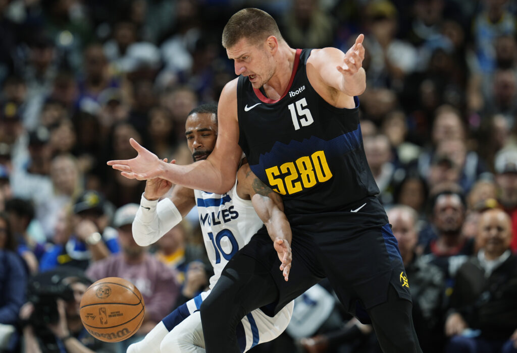 Denver Nuggets center Nikola Jokic, front, reacts as he loses the ball to Minnesota Timberwolves guard Mike Conley in the second half of Game 2 of an NBA basketball second-round playoff series, Monday, May 6, 2024, in Denver. (AP Photo/David Zalubowski)