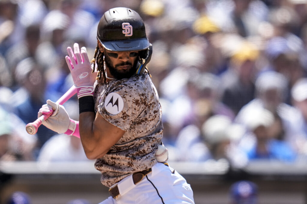 San Diego Padres' Fernando Tatis Jr. is hit by a pitch while batting during the fourth inning of a baseball game against the Los Angeles Dodgers, Sunday, May 12, 2024, in San Diego. (AP Photo/Gregory Bull)