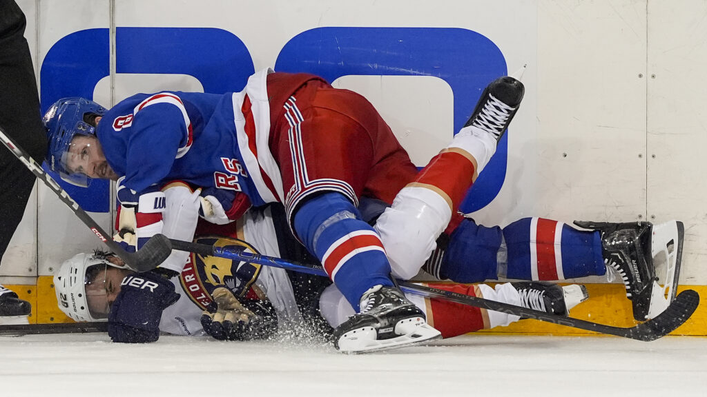 New York Rangers defenseman Jacob Trouba (8) and Florida Panthers center Kevin Stenlund (82) collide during the third period of Game 1 of the NHL hockey Eastern Conference Stanley Cup playoff finals, Wednesday, May 22, 2024, in New York. (AP Photo/Julia Nikhinson)