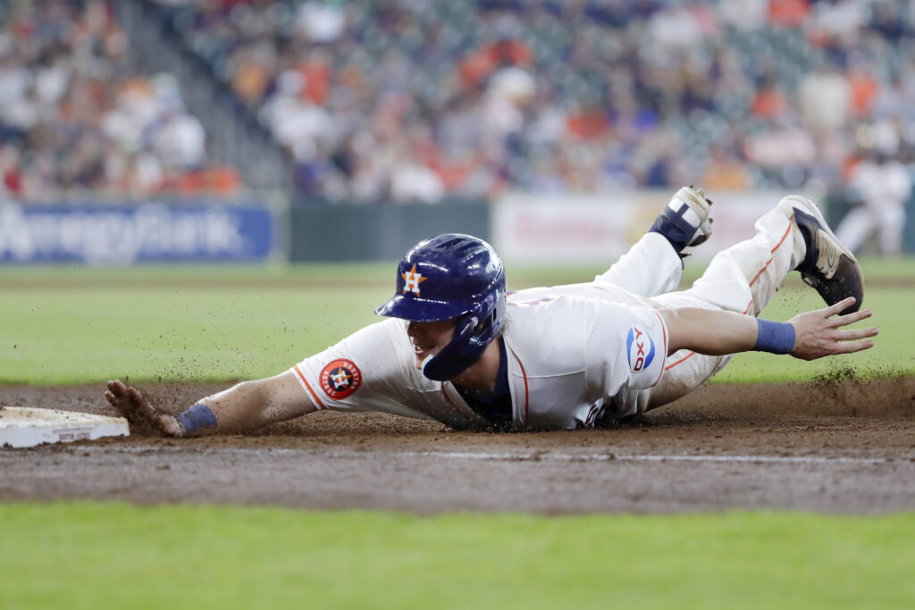 Houston Astros' Jake Meyers beats the tag on a return to first base against the Los Angeles Angels during the seventh inning of a baseball game Wednesday, May 22, 2024, in Houston. (AP Photo/Michael Wyke)