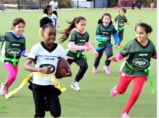 A girls’ flag football game in a New York City park.