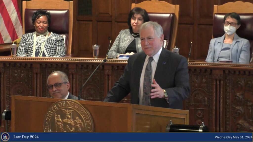 New York State Bar Association President Richard Lewis emphasizes the critical need for meaningful elections and enhanced democratic understanding during his address at the Law Day celebrations in Albany.