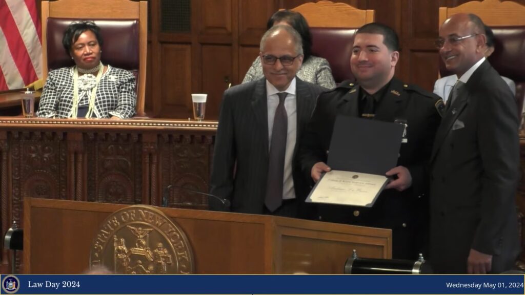 Brooklyn Court Officer Andrew LaBosco stands with Chief Judge Rowan Wilson and First Deputy Chief Administrative Judge Norman St. George, recognized for his outstanding community service at Law Day 2024.