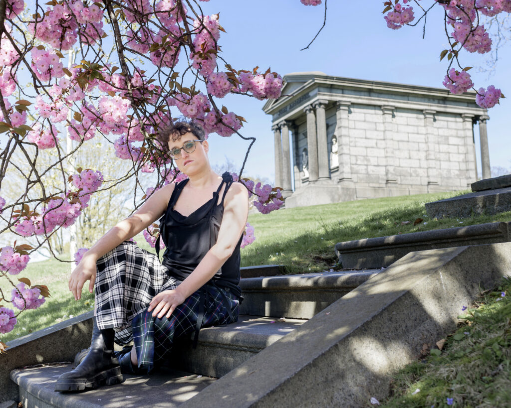 Writer-director Jane Schoenbrun poses for a portrait in Green-Wood Cemetery on Tuesday, April 23, 2024, with a mausoleum in the background. Photos by Christopher Smith/Invision/AP