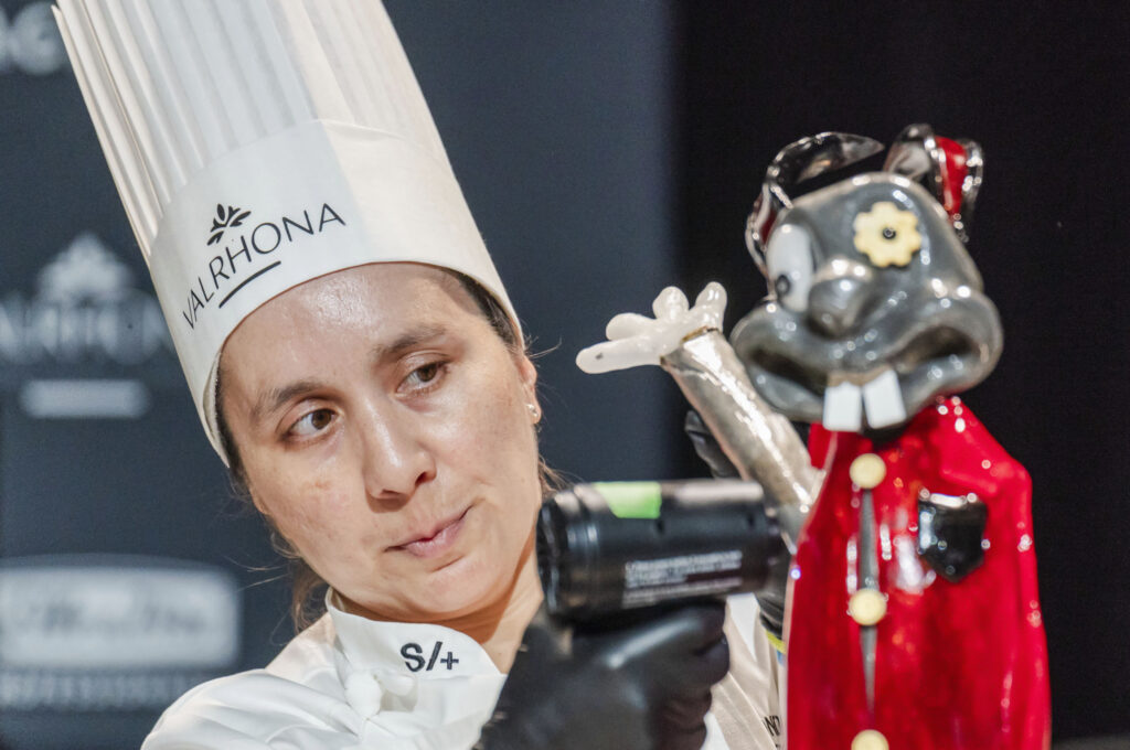 Nadia Castillo, of Chile, adds an arm to her display during the Coupe de Monde de la Patisserie, or World Pastry Cup, at the Ernest N. Morial Convention Center in New Orleans, Tuesday, June 11, 2024. (Matthew Perschall/The Times-Picayune/The New Orleans Advocate via AP)