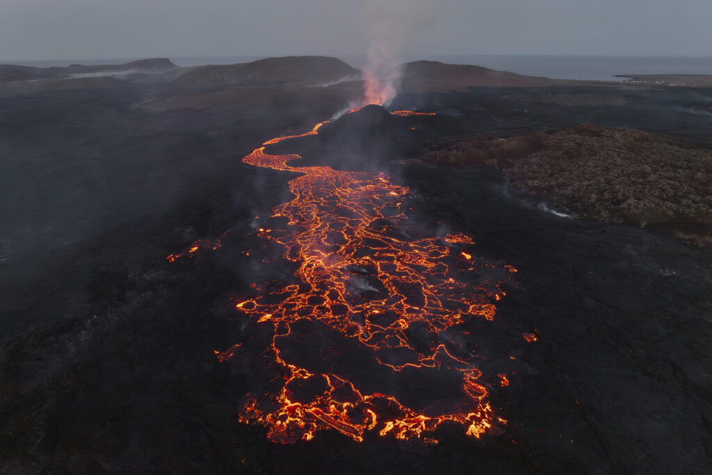 An overall view of the eruption site of the volcano near Grindavik, Iceland, Monday, June 10, 2024. A volcano in southwestern Iceland has been erupting spewing red lava close to the coastal town of Grindavik. (AP Photo/Marco di Marco)