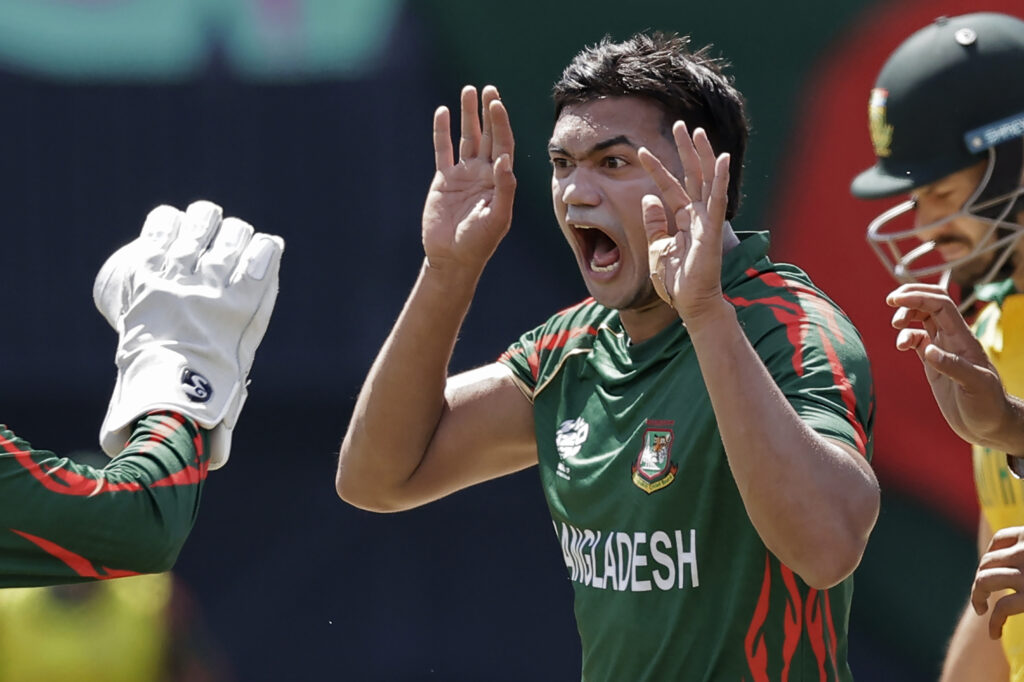 Bangladesh's Taskin Ahmed celebrates the dismissal of South Africa's captain Aiden Markram, partly seen on right, during the ICC Men's T20 World Cup cricket match between Bangladesh and South Africa at the Nassau County International Cricket Stadium in Westbury, New York, Monday, June 10, 2024. (AP Photo/Adam Hunger)