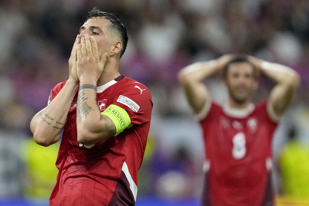 Switzerland's Granit Xhaka holds his face after missing a chance to score during a Group A match between Switzerland and Germany at the Euro 2024 soccer tournament in Frankfurt, Germany, Sunday, June 23, 2024. (AP Photo/Darko Vojinovic)