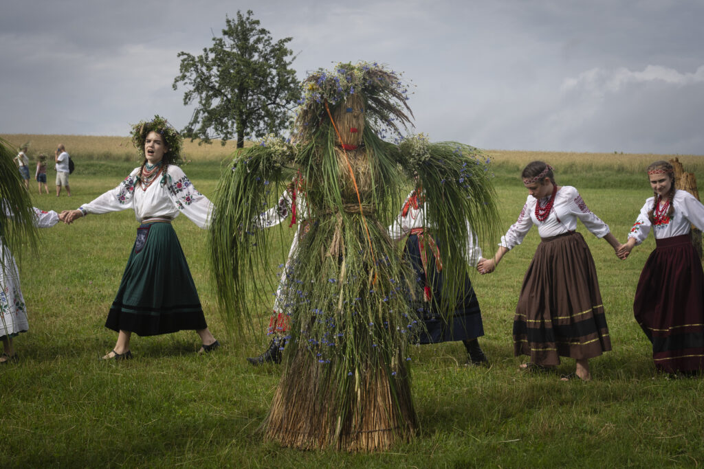 Ukrainian young women dressed in traditional clothing dance in circle at a traditional Midsummer Night celebration near capital Kyiv, Ukraine, Sunday, June 23, 2024. The age-old pagan festival is still celebrated in Ukraine amid the third year of Russia-Ukraine war. (AP Photo/Efrem Lukatsky)