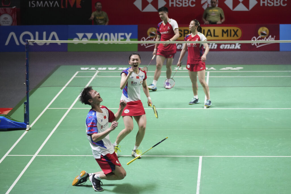 China's Jiang Zhen Bang, left, and Wei Ya Xin celebrate after defeating their compatriots Zheng Si Wei, top left, and Huang Ya Qiong during their mixed doubles final match at the Indonesia Open badminton tournament at Istora Stadium in Jakarta, Indonesia, Sunday, June 9, 2024. (AP Photo/Tatan Syuflana)