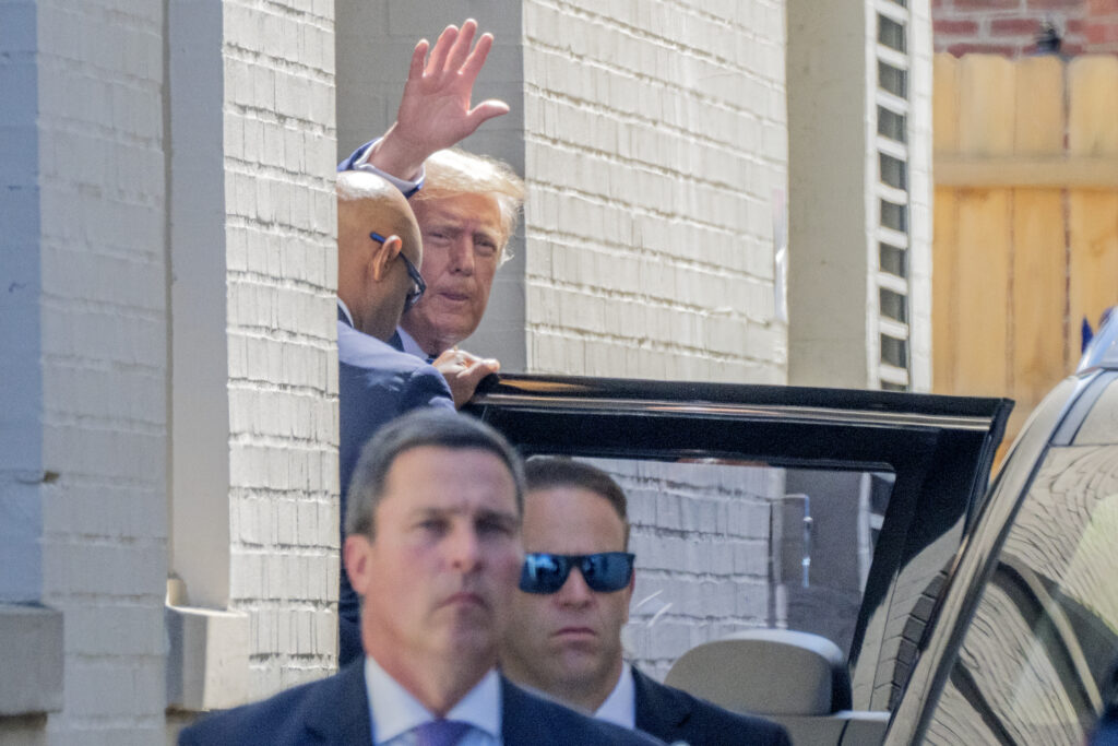 Republican presidential candidate and former President Donald Trump waves as he departs the Capitol Hill Club, Thursday, June 13, 2024, in Washington. (AP Photo/Jacquelyn Martin)