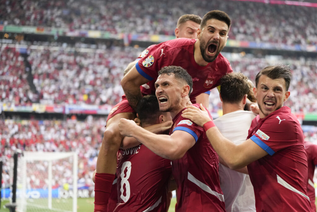 Serbia's players celebrate their sides first goal against Slovenia during a Group C match between Slovenia and Serbia at the Euro 2024 soccer tournament in Munich, Germany, Thursday, June 20, 2024. (AP Photo/Matthias Schrader)