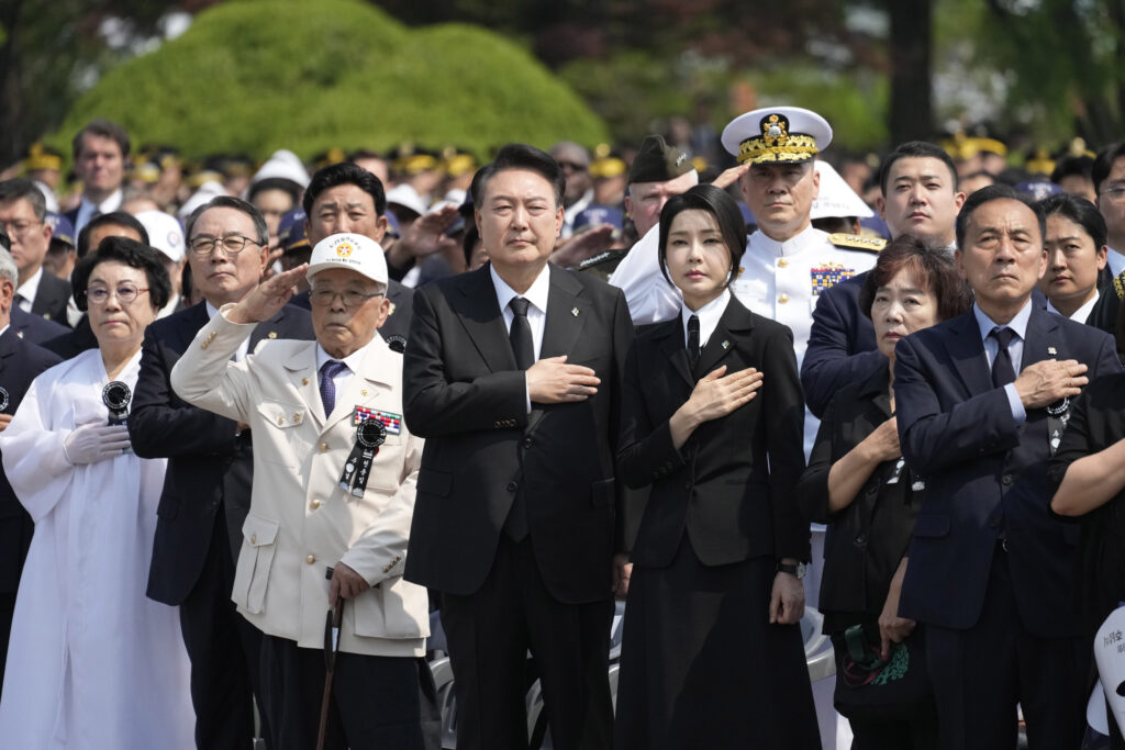 South Korean President Yoon Suk Yeol, center left, and his wife Kim Keon Hee, center right, salute during a ceremony to mark the 69th Memorial Day at the Seoul National Cemetery in Seoul, South Korea, Thursday, June 6, 2024. (AP Photo/Lee Jin-man, Pool)