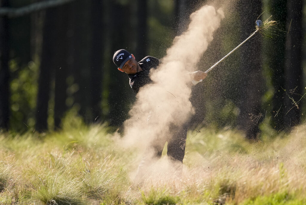 Xander Schauffele hits from the native area on the 11th hole during the second round of the U.S. Open golf tournament Friday, June 14, 2024, in Pinehurst, N.C. (AP Photo/George Walker IV)