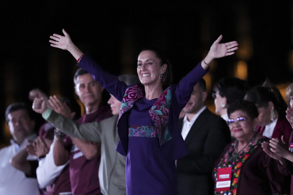 President-elect Claudia Sheinbaum waves to supporters at the Zocalo, Mexico City's main square, after the National Electoral Institute announced she held an irreversible lead in the election, early Monday, June 3, 2024. (AP Photo/Marco Ugarte)