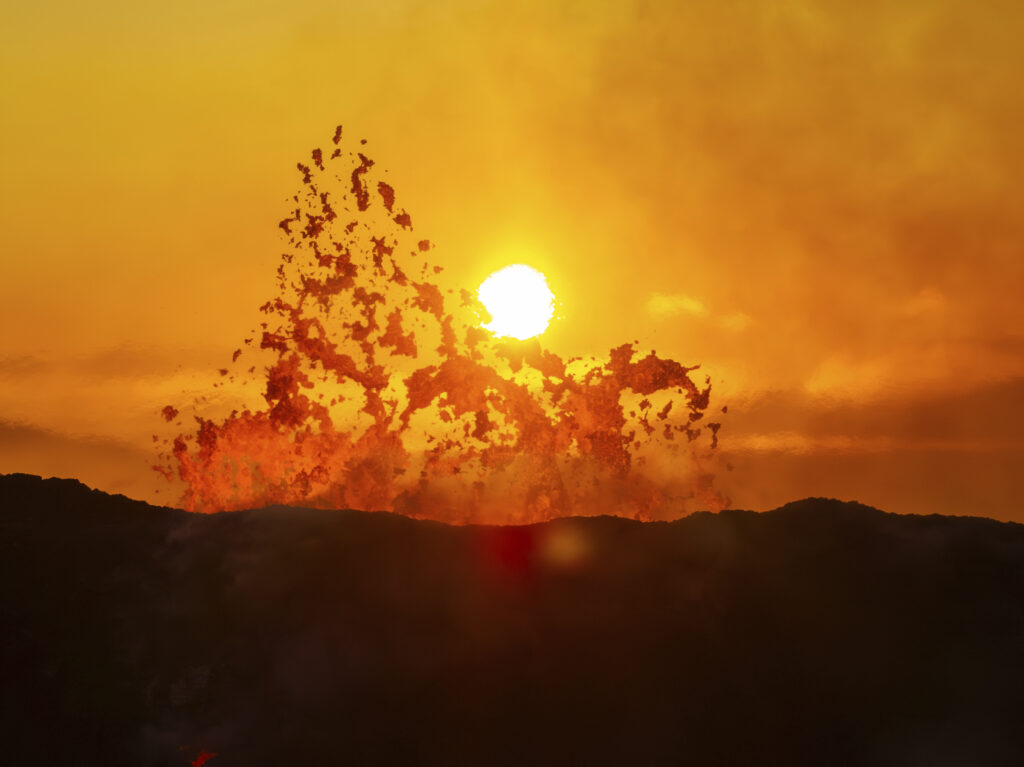 The sun rises above the active crater of the volcano near Grindavik, Iceland, Monday, June 10, 2024. A volcano in southwestern Iceland has been erupting spewing red lava close to the coastal town of Grindavik. (AP Photo/Marco di Marco)