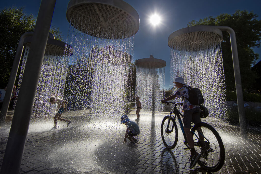 Children cool off in a public fountain in Vilnius, Lithuania, Thursday, June 27, 2024. A heat wave continues in Lithuania as temperatures rise to a high of 32 degrees Celsius (89.6 degrees Fahrenheit). (AP Photo/Mindaugas Kulbis)